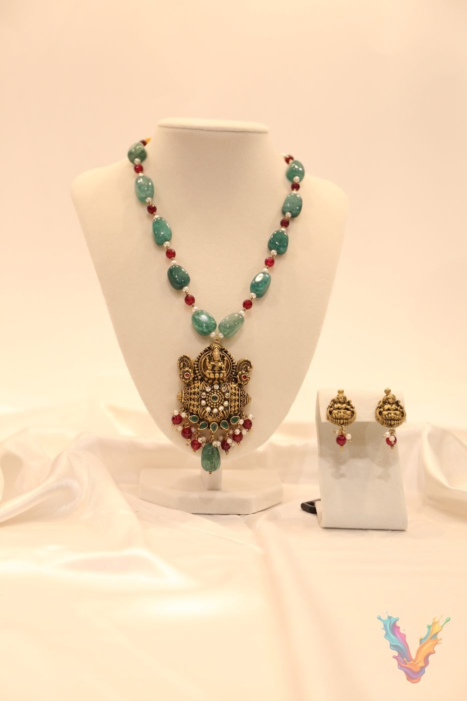 Green beaded terracotta necklace with a gold pendant and earrings